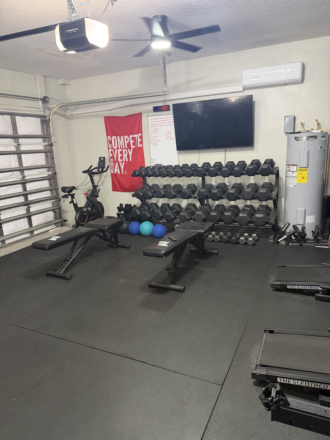Nick’s private gym with dumbbells, benches, conditioning equipment, and open training space